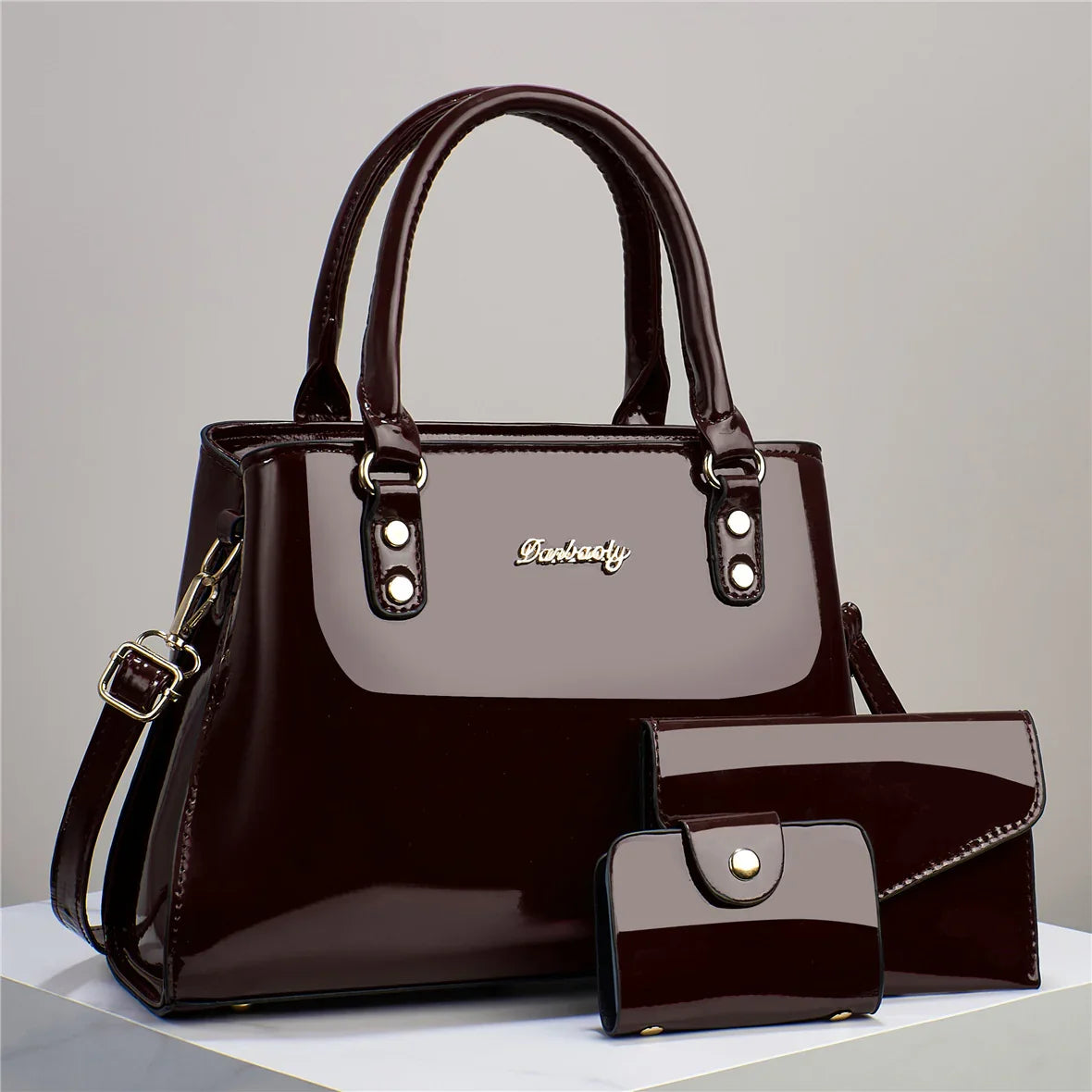Classic black glossy patent leather 3-piece luxury bag set including handbag, wallet, and clutch