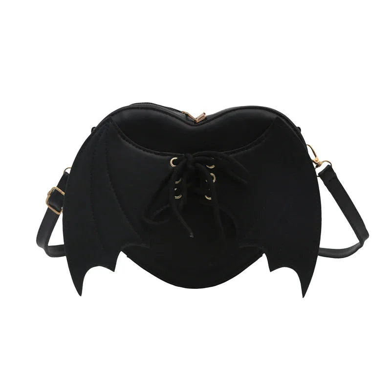 Black bat wing handbag with lace-up front and adjustable shoulder strap against white background