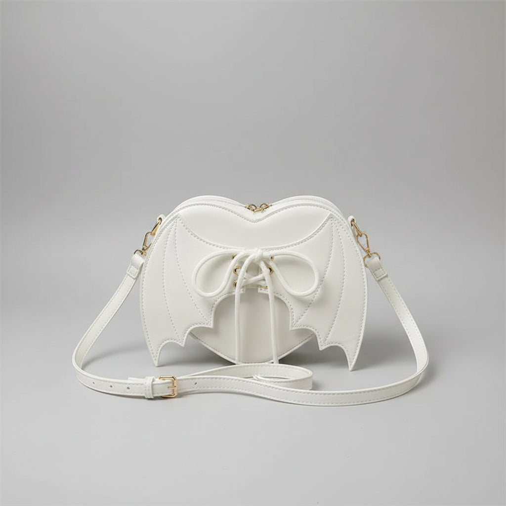 White heart-shaped shoulder bag with bat wings and lace-up front, trendy fashion accessory