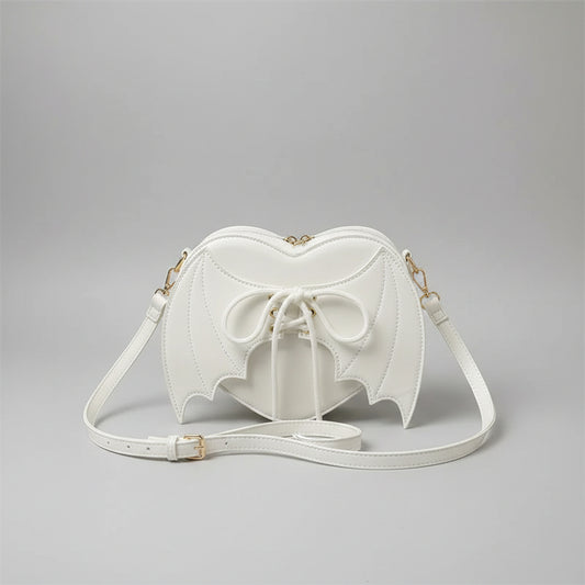 White heart-shaped shoulder bag with bat wings and lace-up front, trendy fashion accessory